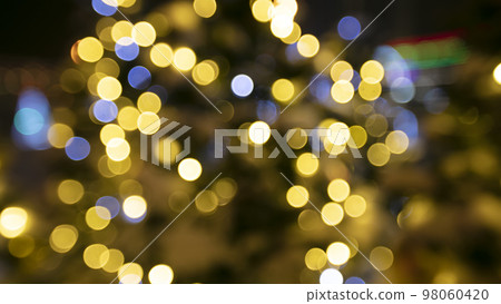 Golden lights of optical bokeh on a dark background. Golden lights of optical bokeh on a dark background. 98060420