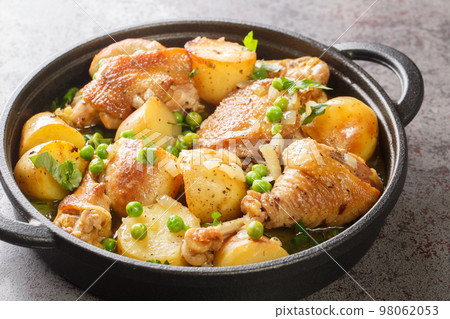 Chicken Vesuvio is pan-seared and baked chicken, potatoes, and peas with a ridiculously delicious herbed wine sauce close-up in a frying pan. Horizontal Chicken Vesuvio is pan-seared and baked chicken, potatoes, and peas with a ridiculously delicious herbed wine sauce close-up in a frying pan. Horizontal 98062053