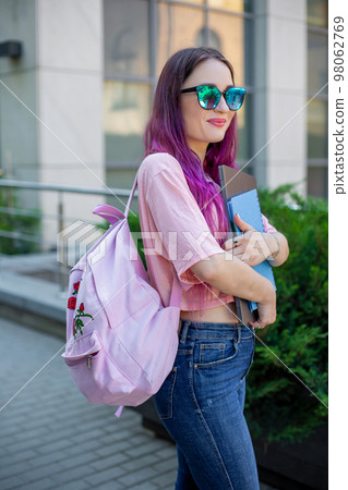 Portrait beautiful female writer dressed in casual outfit holding modern laptop in hand with backpack. 98062769