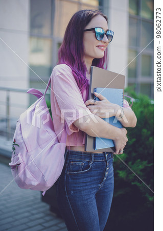 Portrait beautiful female writer dressed in casual outfit holdin Portrait beautiful female writer dressed in casual outfit holdin 98062773