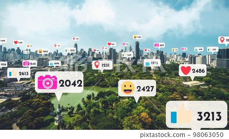 Social media icons fly over city downtown showing people reciprocity connection Social media icons fly over city downtown showing people reciprocity connection 98063050