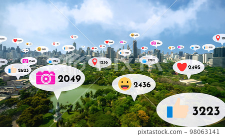 Social media icons fly over city downtown showing people reciprocity connection 98063141