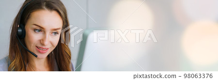 Business people wearing headset working in office in widen view 98063376