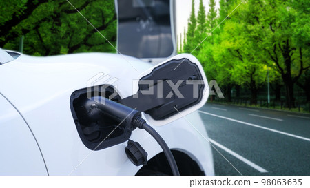 Progressive green city ESG style background with electric vehicle. Progressive green city ESG style background with electric vehicle. 98063635