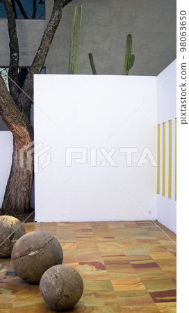 interior of the gilardi house of the famous architect luis barragan, central courtyard, with stone spheres and jacaranda tree 98063650