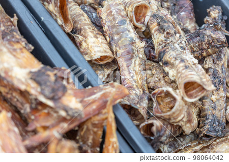 Close up of dried meat for a dog, snack for doggy, animal food concept Close up of dried meat for a dog, snack for doggy, animal food concept 98064042
