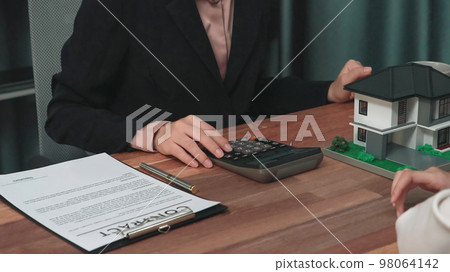 Closeup enthusiastic customer review contract paperwork for house loan. Closeup enthusiastic customer review contract paperwork for house loan. 98064142