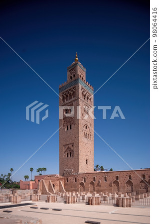 Koutoubia Mosque Minaret in Morocco Marrakesh and gardens during sunset with blue sky. Inside Medina. Koutoubia Mosque Minaret in Morocco Marrakesh and gardens during sunset with blue sky. Inside Medina. 98064416