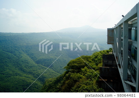 view of a natural ravine, with green vegetation, steel and glass school building overlooking the ravine view of a natural ravine, with green vegetation, steel and glass school building overlooking the ravine 98064481
