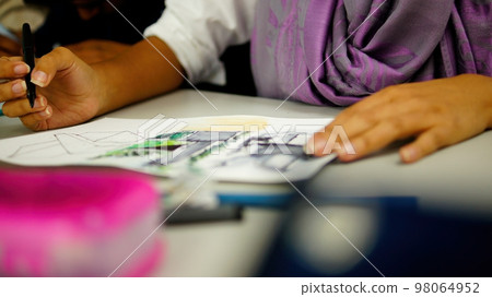 person drawing by hand with pen, pencil and ink, architectural perspectives, in color. 98064952