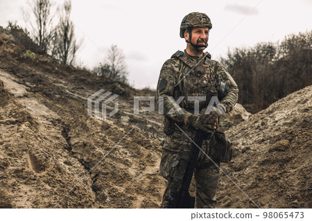 A soldier standing in a dig-position A soldier standing in a dig-position 98065473