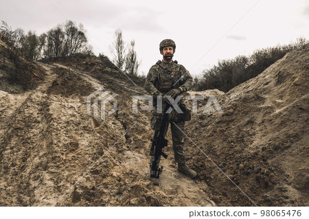A soldier standing in a dig-position A soldier standing in a dig-position 98065476