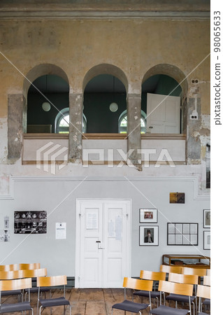 three large windows, with a desk and chair at the bottom, is an academic exhibition of architecture three large windows, with a desk and chair at the bottom, is an academic exhibition of architecture 98065633