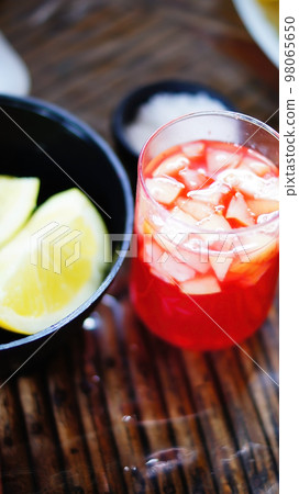 selective approach, alcoholic beverage of tequila, apple and pineapple, lemon and salt to drink with tequila, in a glass selective approach, alcoholic beverage of tequila, apple and pineapple, lemon and salt to drink with tequila, in a glass 98065650