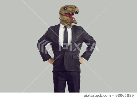 Portrait of serious confident businessman with dinosaur head isolated on gray background. 98065889