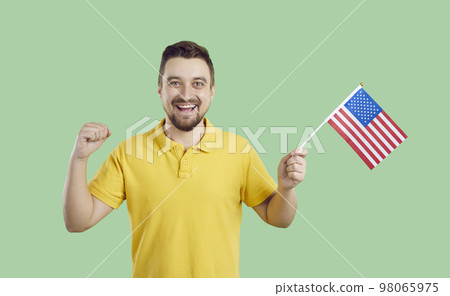 Happy young American guy with flag of United States celebrating Independence Day 98065975