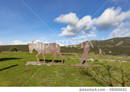 Mountains. Green mountains in the municipality of El Atazar, north of the Community of Madrid. Sunny day with air and clouds decorating the sky. Iron decoration on the green grass. Farmer. Donkey. Mountains. Green mountains in the municipality of El Atazar, north of the Community of Madrid. Sunny day with air and clouds decorating the sky. Iron decoration on the green grass. Farmer. Donkey. 98066682
