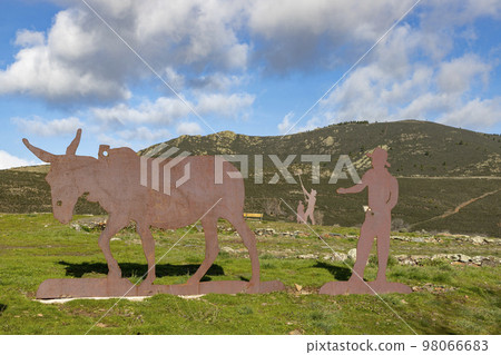 Mountains. Green mountains in the municipality of El Atazar, north of the Community of Madrid. Sunny day with air and clouds decorating the sky. Iron decoration on the green grass. Farmer. Donkey. Mountains. Green mountains in the municipality of El Atazar, north of the Community of Madrid. Sunny day with air and clouds decorating the sky. Iron decoration on the green grass. Farmer. Donkey. 98066683