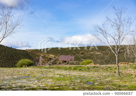 Mountains. Green mountains in the municipality of El Atazar, north of the Community of Madrid. Sunny day with air and clouds decorating the sky. Iron decoration on the green grass. Farmer. Donkey. Mountains. Green mountains in the municipality of El Atazar, north of the Community of Madrid. Sunny day with air and clouds decorating the sky. Iron decoration on the green grass. Farmer. Donkey. 98066687
