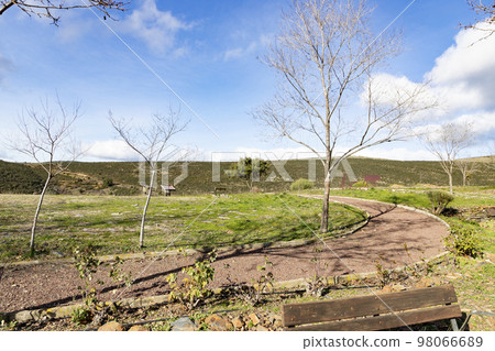 Mountains. Green mountains in the municipality of El Atazar, north of the Community of Madrid. Sunny day with air and clouds decorating the sky. Iron decoration on the green grass. Farmer. Donkey. Mountains. Green mountains in the municipality of El Atazar, north of the Community of Madrid. Sunny day with air and clouds decorating the sky. Iron decoration on the green grass. Farmer. Donkey. 98066689