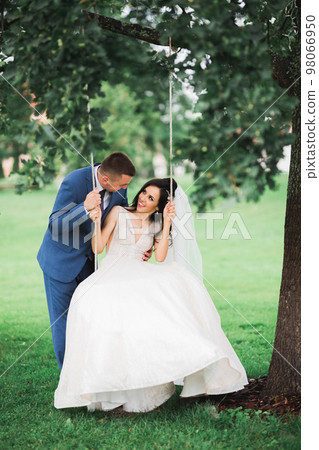 Gorgeous happy couple standing close to each other and looking in eyes Gorgeous happy couple standing close to each other and looking in eyes 98066950