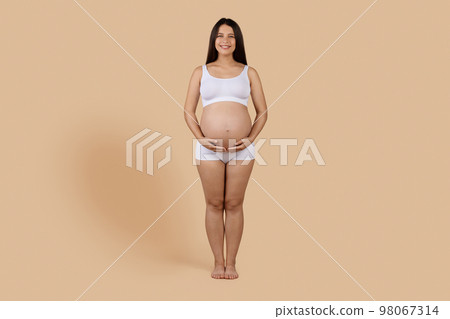 Healthy Pregnancy. Portrait Of Smiling Young Expectant Female In Underwear 98067314