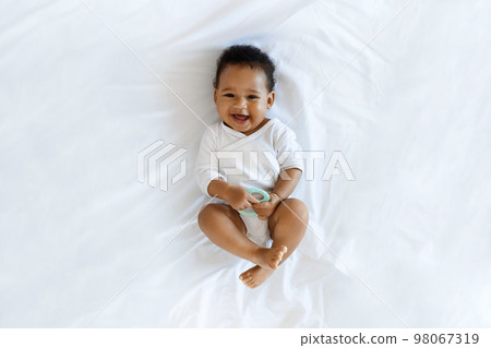 Child Care. Top View Of Adorable Black Infant Boy Relaxing On Bed 98067319