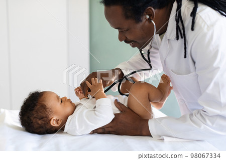 Healthcare Concept. Black Pediatrician Doctor Doing Check Up With Baby In Clinic Healthcare Concept. Black Pediatrician Doctor Doing Check Up With Baby In Clinic 98067334