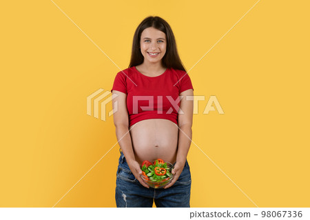 Beautiful Young Pregnant Woman With Bowl Of Fresh Vegetable Salad In Hands Beautiful Young Pregnant Woman With Bowl Of Fresh Vegetable Salad In Hands 98067336