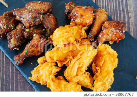 caramelized chicken with sesame and garlic, meat strips in breadin. caramelized chicken with sesame and garlic, meat strips in breadin. 98067765