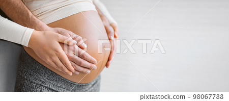 Pregnant woman holding belly with man. Happy expecting family pregnancy banner background. Couple in love Pregnant woman holding belly with man. Happy expecting family pregnancy banner background. Couple in love 98067788
