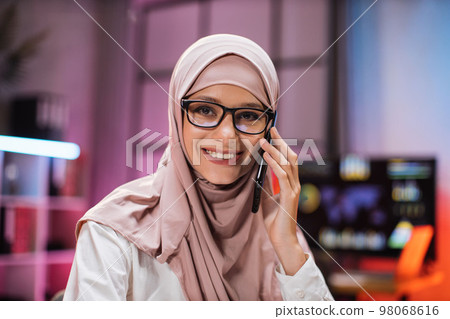 Close up portrait of attractive concentrated hardworking muslim businesswoman Close up portrait of attractive concentrated hardworking muslim businesswoman 98068616