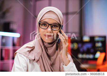 Close up portrait of attractive concentrated hardworking muslim businesswoman 98068618