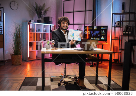 Handsome successful qualified bearded office manager in suit wears headset during online video call 98068823