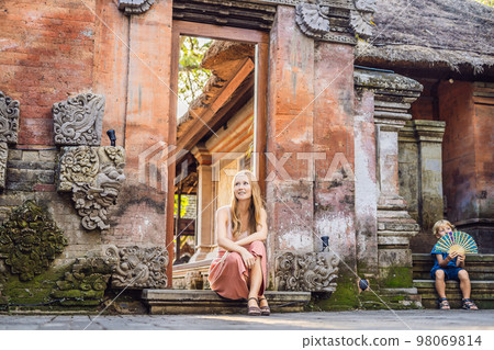 Young woman traveler in Ubud palace, Bali - Inside the Ubud palace, Bali, Indonesia 98069814