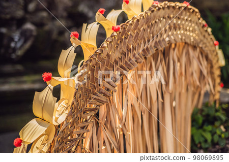Traditional Bali Penjor - bamboo pole with decoration on village street Indonesian art and culture. Travel background Traditional Bali Penjor - bamboo pole with decoration on village street Indonesian art and culture. Travel background 98069895