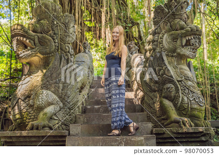 Young woman tourist explores the Monkey Forest in Ubud, Bali, Indonesia 98070053