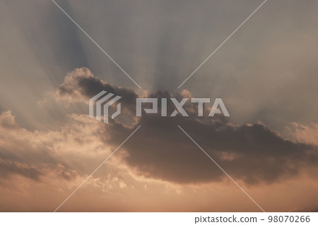 A flash of light coming through the clouds 98070266