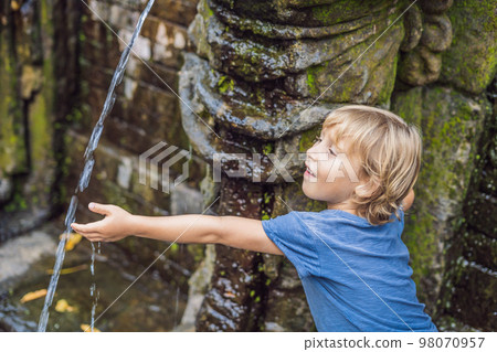 Boy tourist in Old Hindu temple of Goa Gajah near Ubud on the island of Bali, Indonesia. Travel in Bali with children concept Boy tourist in Old Hindu temple of Goa Gajah near Ubud on the island of Bali, Indonesia. Travel in Bali with children concept 98070957
