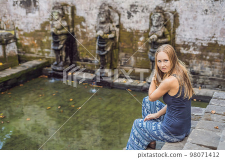 Woman tourist in Old Hindu temple of Goa Gajah near Ubud on the island of Bali, Indonesia Woman tourist in Old Hindu temple of Goa Gajah near Ubud on the island of Bali, Indonesia 98071412