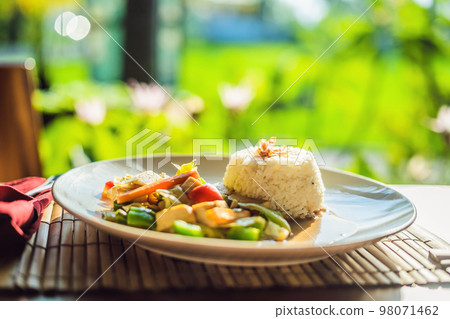 Traditional Balinese cuisine. Vegetable and tofu stir-fry with rice 98071462
