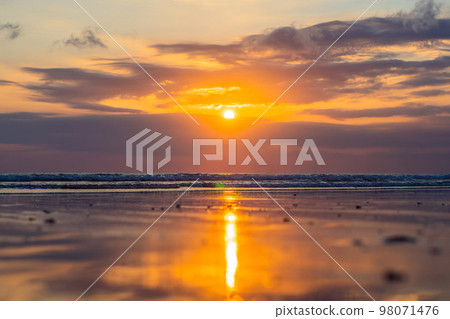 Sunset on the Kuta beach with reflection in the water on the island of Bali 98071476