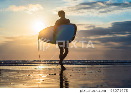 Vacation Silhouette Of A Surfer Carrying His Surf Board Home At Sunset With Copy Space Vacation Silhouette Of A Surfer Carrying His Surf Board Home At Sunset With Copy Space 98071478