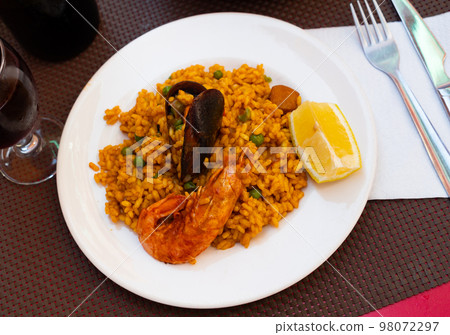 Just cooked paella de marisco on table Just cooked paella de marisco on table 98072297