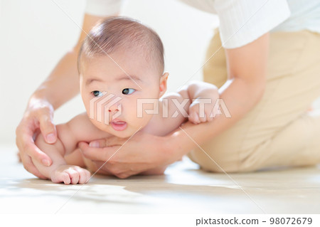 Parent and child practicing tossing and turning Mom's support 4 months old Copy space 98072679