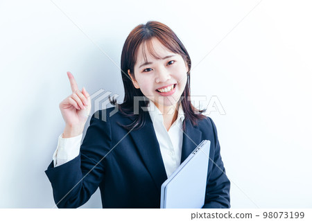Business woman in a suit holding a computer 98073199
