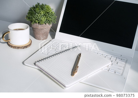 Desk with laptop, coffee and empty diary Desk with laptop, coffee and empty diary 98073375
