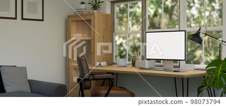 Minimal home working room with PC computer mockup on wood table against the window 98073794