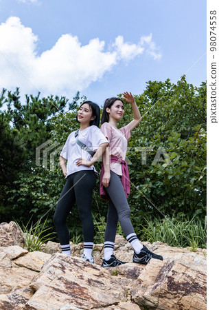 korean young women hiking and plogging_standing on the rock korean young women hiking and plogging_standing on the rock 98074558