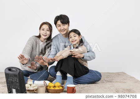 happy Asian Korean family, isolated in white background_warm oneself at a stove 98074708